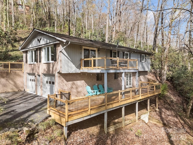 159 Long John Dr, Hendersonville, NC 28791 - rear view of property with a balcony, an attached garage, aphalt driveway, brick siding, and a deck