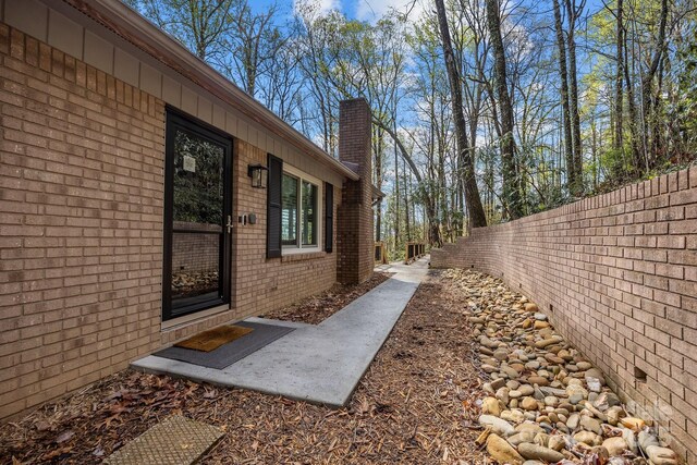 159 Long John Dr, Hendersonville, NC 28791 - view of property exterior featuring a chimney, fence, and brick siding