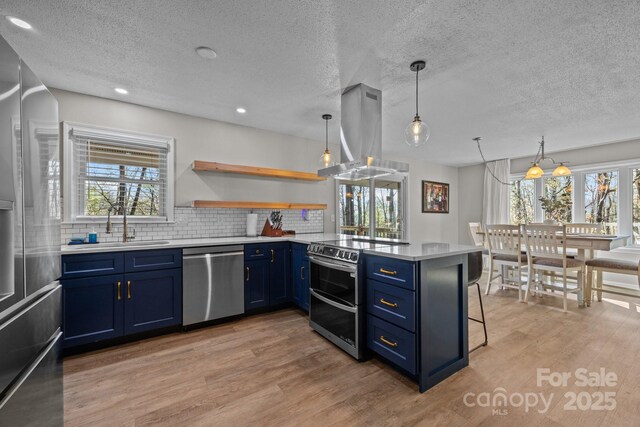 159 Long John Dr, Hendersonville, NC 28791 - kitchen featuring light wood finished floors, appliances with stainless steel finishes, blue cabinets, and island exhaust hood