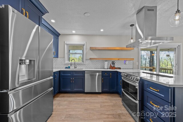 159 Long John Dr, Hendersonville, NC 28791 - kitchen with stainless steel appliances, light countertops, blue cabinets, and wall chimney range hood