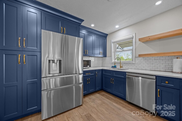 159 Long John Dr, Hendersonville, NC 28791 - kitchen featuring stainless steel appliances, light countertops, blue cabinetry, and a sink