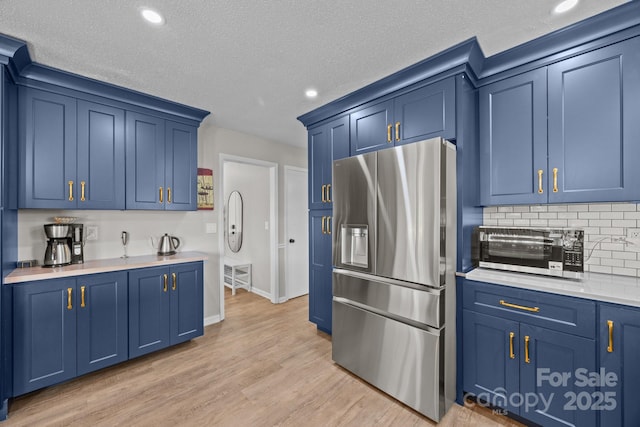 159 Long John Dr, Hendersonville, NC 28791 - kitchen featuring blue cabinetry, recessed lighting, light countertops, stainless steel fridge, and light wood finished floors