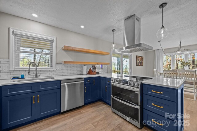 159 Long John Dr, Hendersonville, NC 28791 - kitchen with a textured ceiling, wall chimney range hood, blue cabinetry, a sink, and stainless steel appliances