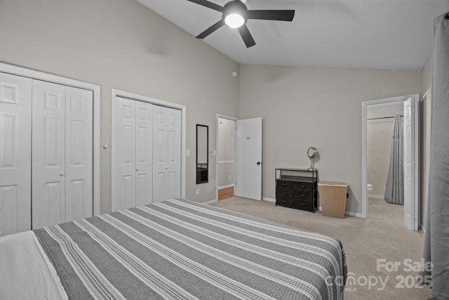 159 Long John Dr, Hendersonville, NC 28791 - carpeted bedroom featuring two closets, ensuite bathroom, high vaulted ceiling, a ceiling fan, and baseboards