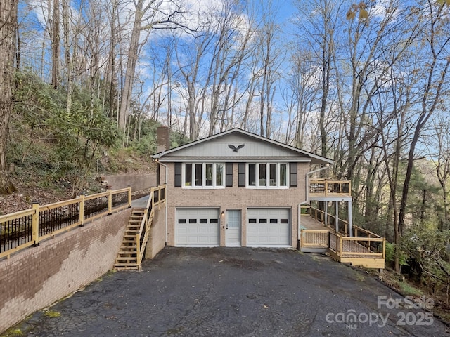 159 Long John Dr, Hendersonville, NC 28791 - view of home's exterior featuring brick siding, aphalt driveway, an attached garage, and stairs