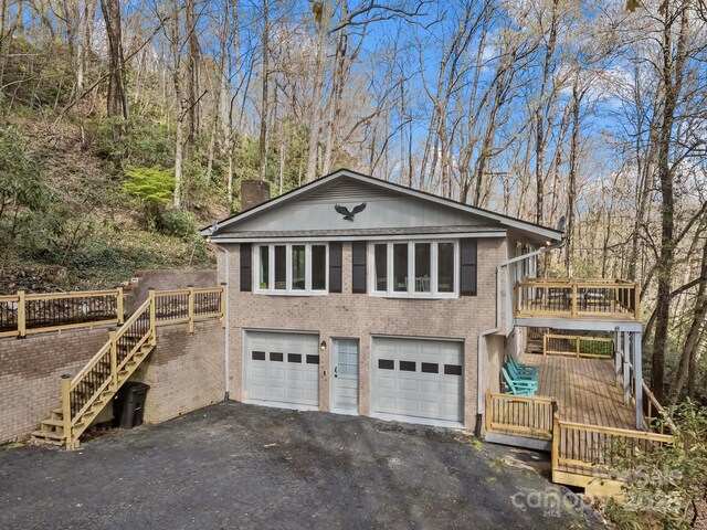 159 Long John Dr, Hendersonville, NC 28791 - exterior space featuring brick siding, stairway, a garage, and driveway