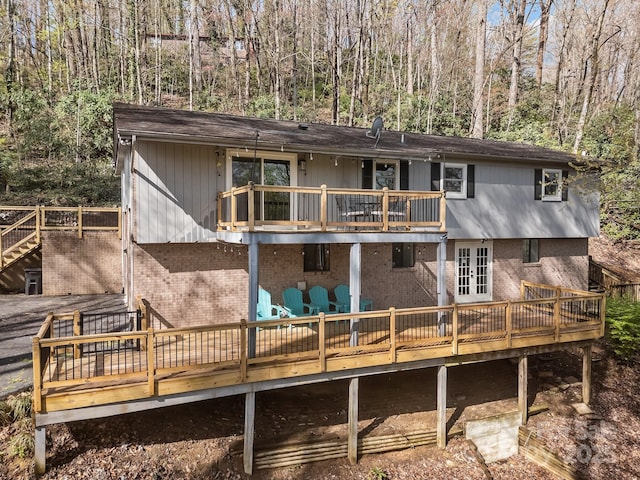 159 Long John Dr, Hendersonville, NC 28791 - back of house with a deck, a wooded view, a balcony, brick siding, and french doors
