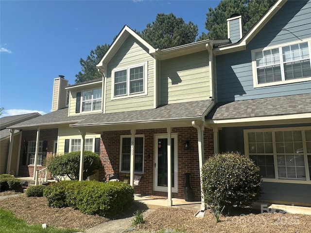 9305 Four Mile Creek Rd, Charlotte, NC 28277 - view of front of house featuring a chimney, brick siding, and a shingled roof