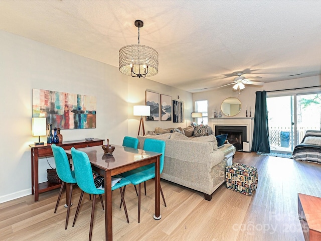 9305 Four Mile Creek Rd, Charlotte, NC 28277 - dining room with a fireplace, a wealth of natural light, wood finished floors, and ceiling fan with notable chandelier