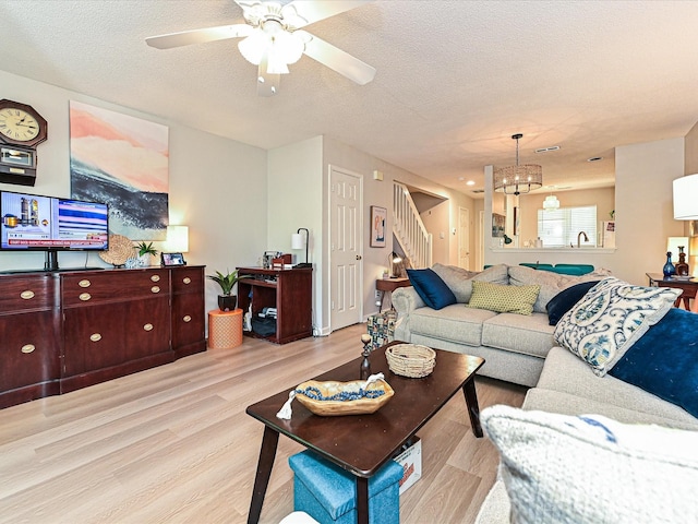 9305 Four Mile Creek Rd, Charlotte, NC 28277 - living room with stairway, a textured ceiling, ceiling fan with notable chandelier, and wood finished floors