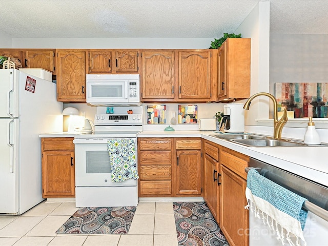 9305 Four Mile Creek Rd, Charlotte, NC 28277 - kitchen with brown cabinetry, white appliances, a textured ceiling, and a sink
