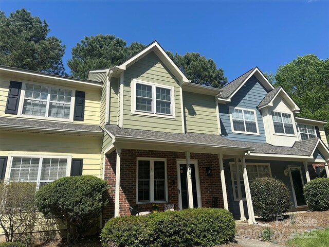 9305 Four Mile Creek Rd, Charlotte, NC 28277 - view of front of house with covered porch, brick siding, and roof with shingles