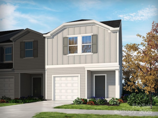 view of front facade featuring board and batten siding, a garage, and driveway