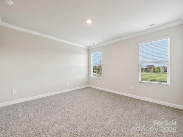 empty room with crown molding, baseboards, carpet flooring, and recessed lighting