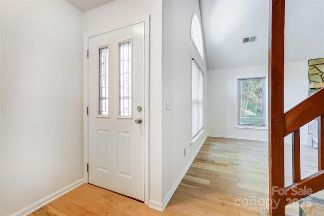 foyer with visible vents, a wealth of natural light, light wood finished floors, and baseboards