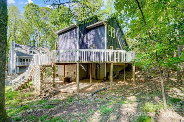 rear view of house with a patio area, stairway, a wooden deck, and cooling unit