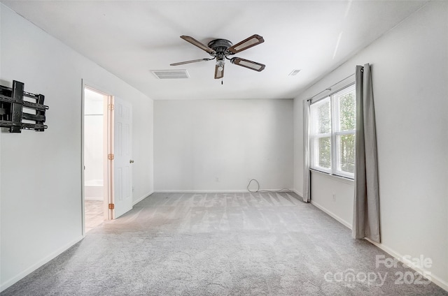 spare room with ceiling fan, baseboards, visible vents, and carpet floors