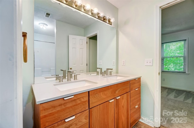 full bathroom featuring a sink, visible vents, and double vanity