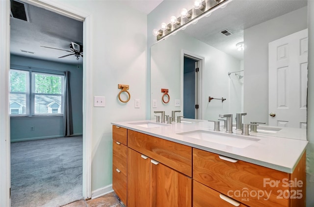 bathroom featuring a sink, a ceiling fan, and visible vents