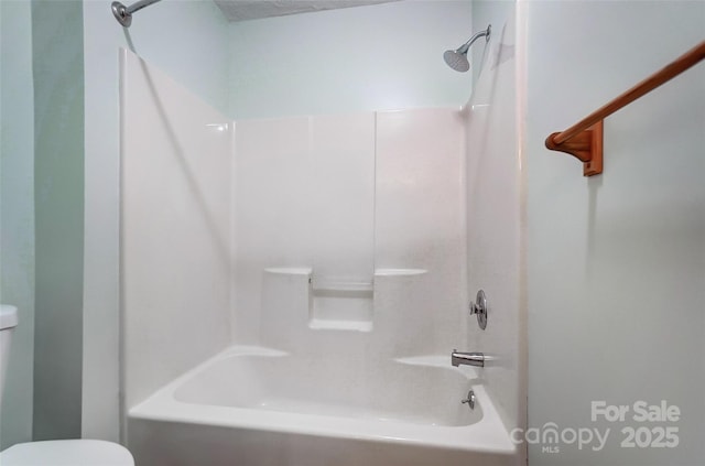 bathroom with toilet and bathtub / shower combination