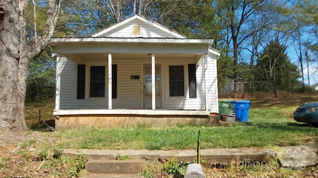 bungalow-style house featuring a porch and metal roof