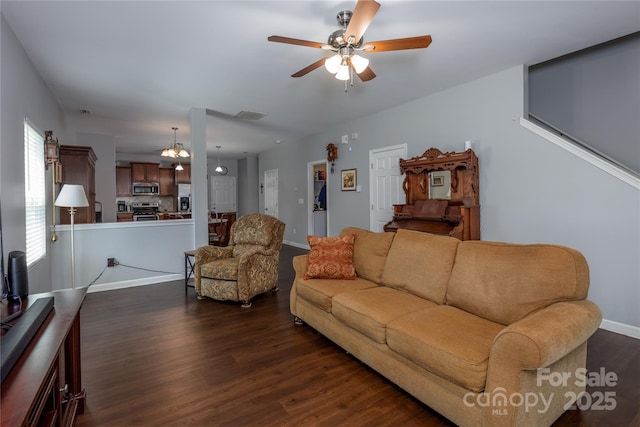 living area featuring a ceiling fan, baseboards, dark wood-style flooring, and visible vents