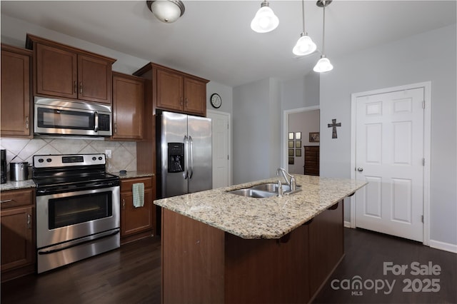 kitchen featuring dark wood finished floors, backsplash, stainless steel appliances, and a sink