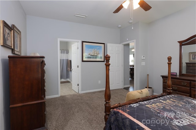 carpeted bedroom featuring baseboards, a ceiling fan, visible vents, and ensuite bathroom