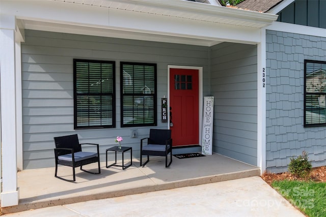 property entrance featuring a porch and board and batten siding