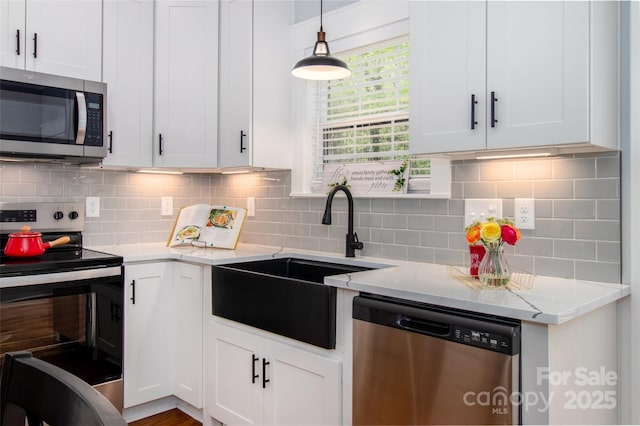 kitchen featuring a sink, white cabinetry, and stainless steel appliances