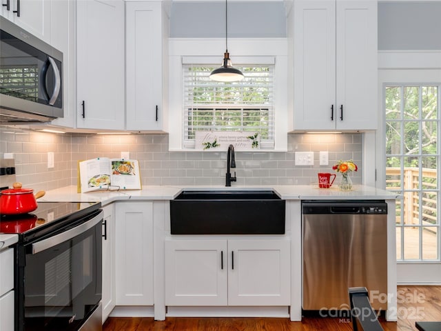 kitchen with white cabinets, stainless steel appliances, and a sink