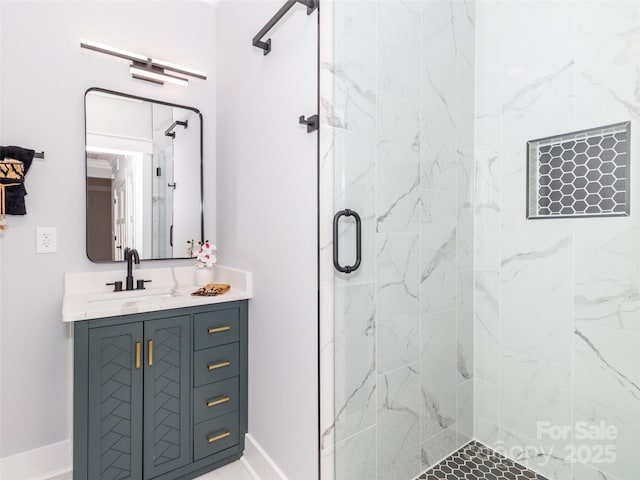bathroom with vanity, baseboards, and a shower stall