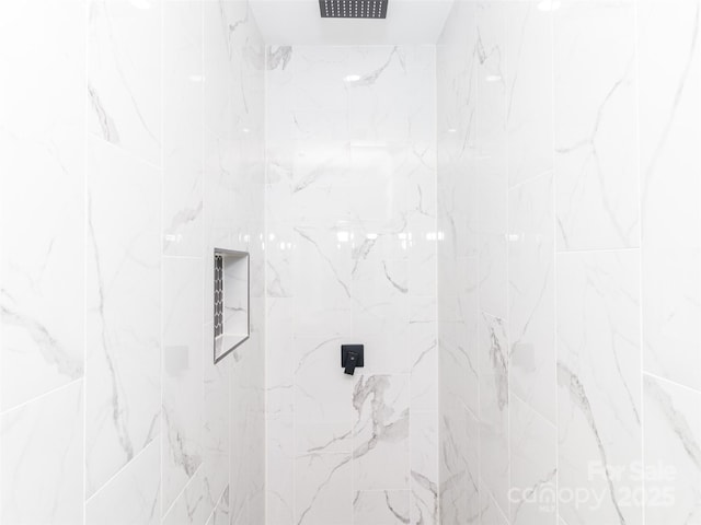 bathroom with a marble finish shower