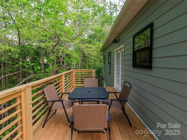 wooden terrace with outdoor dining area