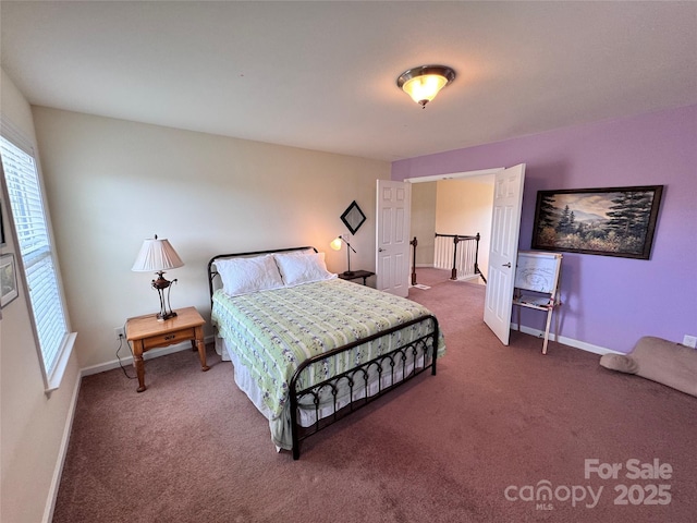 carpeted bedroom with baseboards and multiple windows