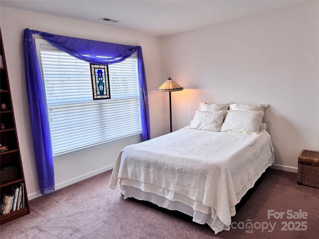 carpeted bedroom with baseboards and visible vents