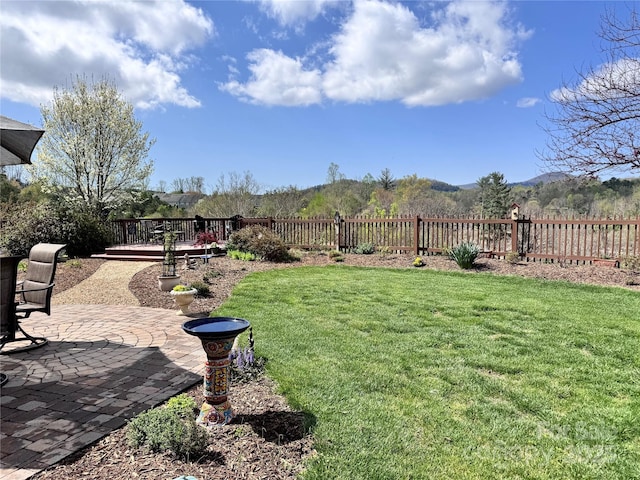 view of yard with fence and a patio