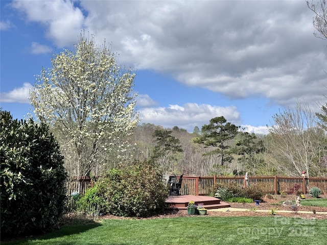 view of yard featuring fence and a wooden deck