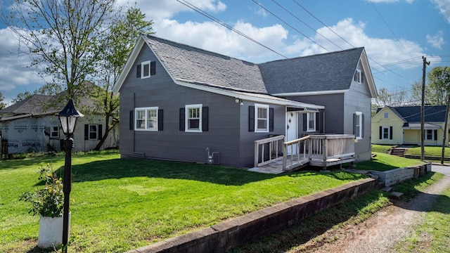 exterior space featuring roof with shingles and a front yard