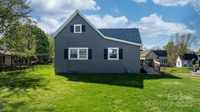 71 14th St SE, Hickory, NC 28602 - rear view of property with a shingled roof and a lawn