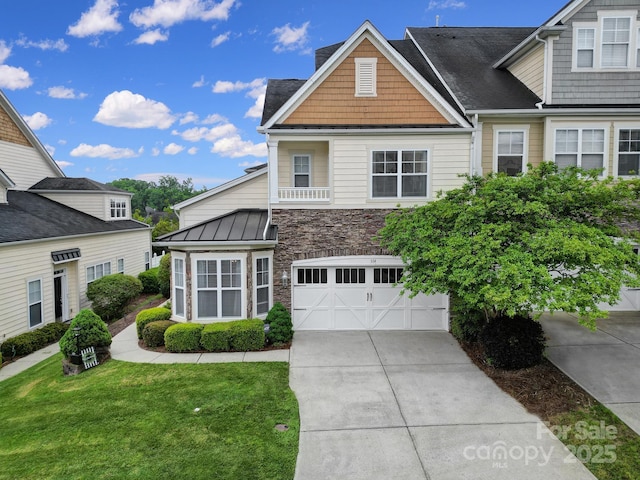 314 Wave Crest Dr, Tega Cay, SC 29708 - view of front of house featuring an attached garage, a standing seam roof, driveway, stone siding, and a front yard
