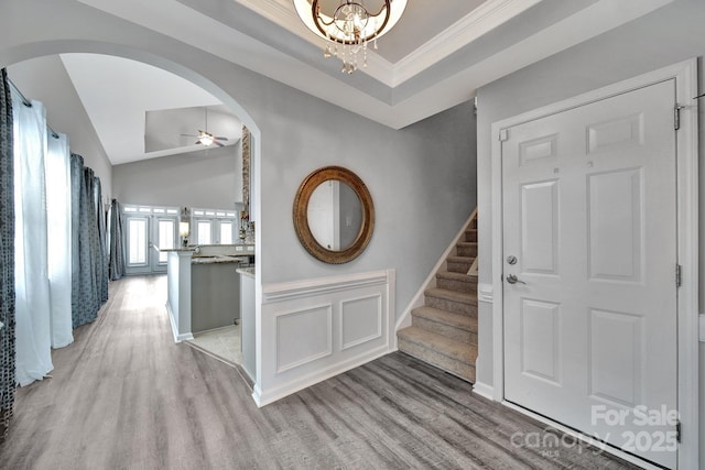314 Wave Crest Dr, Tega Cay, SC 29708 - entryway with arched walkways, stairs, ceiling fan with notable chandelier, and light wood-type flooring