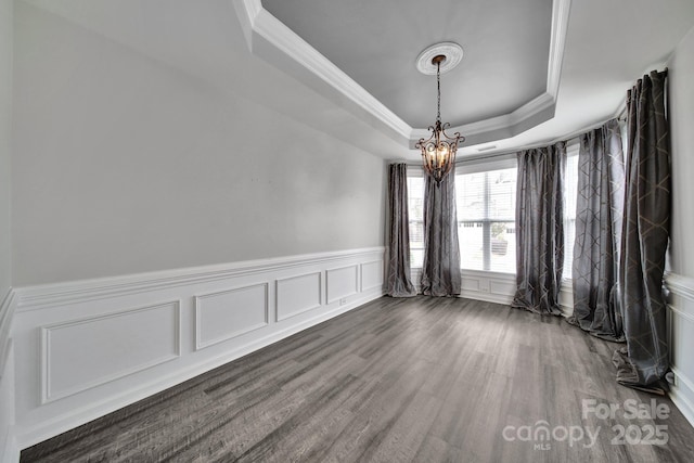 314 Wave Crest Dr, Tega Cay, SC 29708 - empty room with a raised ceiling, a chandelier, ornamental molding, and a decorative wall