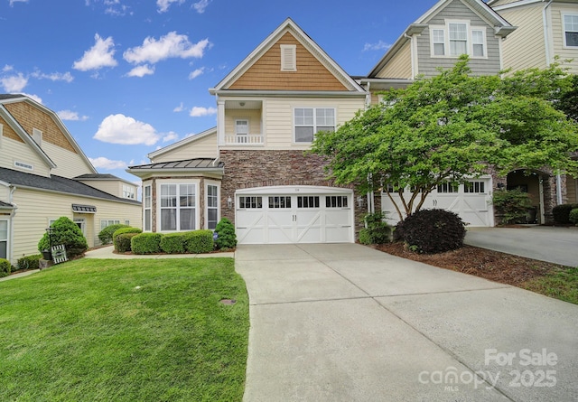314 Wave Crest Dr, Tega Cay, SC 29708 - view of front of house featuring a front lawn, concrete driveway, an attached garage, a standing seam roof, and stone siding