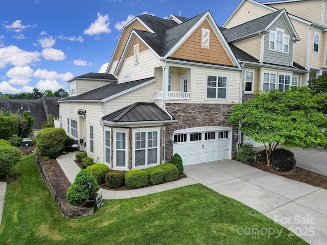314 Wave Crest Dr, Tega Cay, SC 29708 - view of front of home with a front lawn, driveway, stone siding, a garage, and a standing seam roof