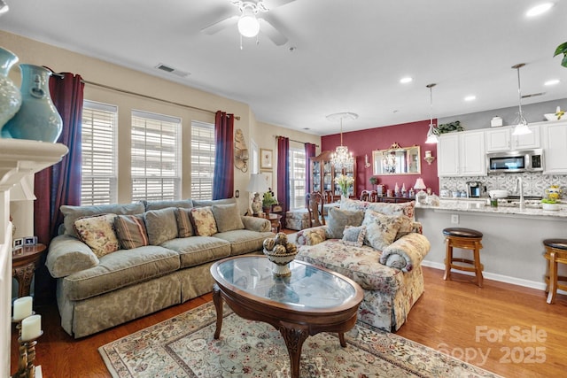living area featuring recessed lighting, visible vents, light wood-type flooring, and ceiling fan