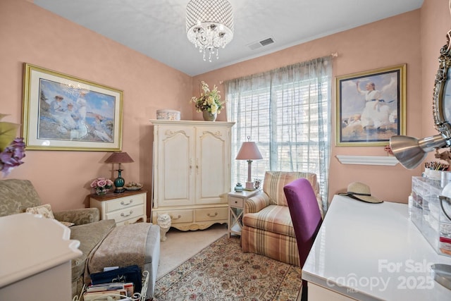 sitting room with a notable chandelier, visible vents, and carpet floors