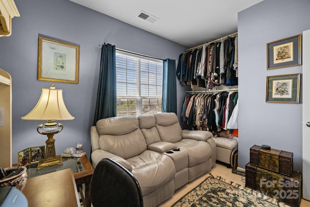 carpeted living area featuring visible vents