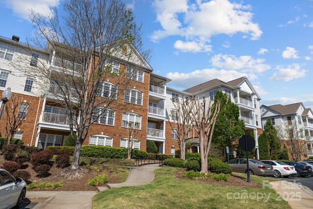 view of property featuring uncovered parking