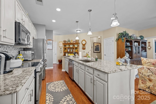 kitchen featuring white cabinetry, dark wood-type flooring, visible vents, appliances with stainless steel finishes, and a sink